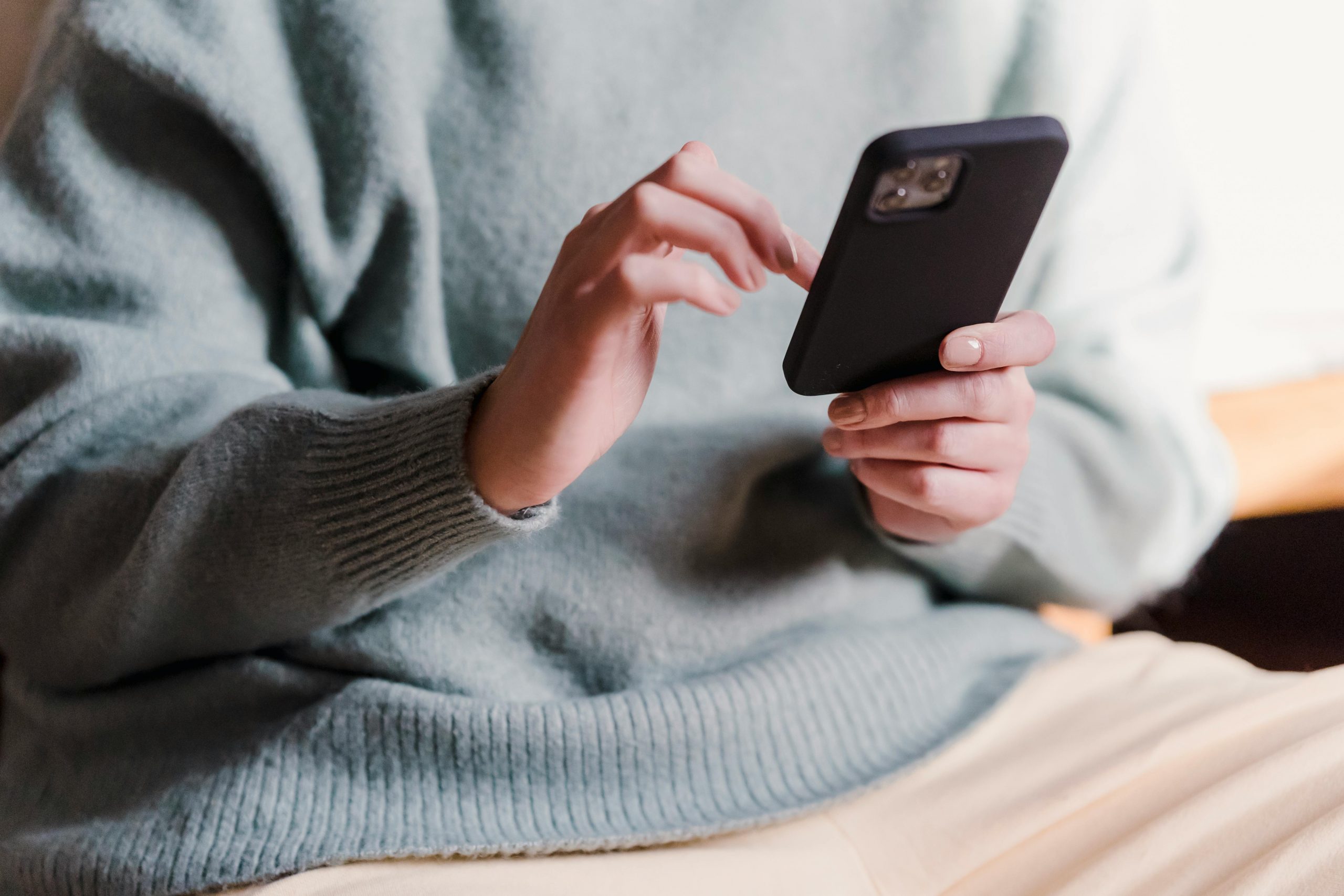 close-up of fingers tapping on a phone screen